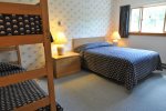 Bedroom with queen bed and set of bunks